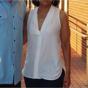 Vince Camuto sleeveless sheer white tank top blouse with plunge neck line.